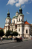 Horse carriage in front of the St. Nicholas Church in the Old Town Square